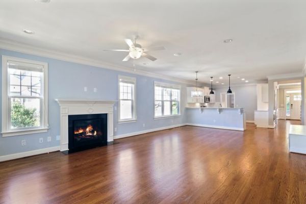 Spacious living room featuring a modern fireplace and wooden flooring 600 Pexels