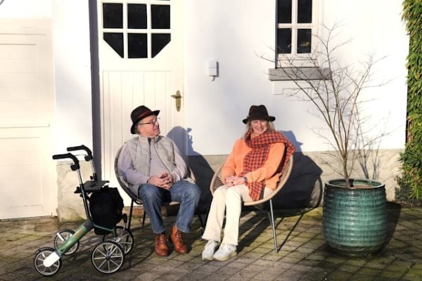 Elderly couple sitting outside with hats and walker 600 Unsplash