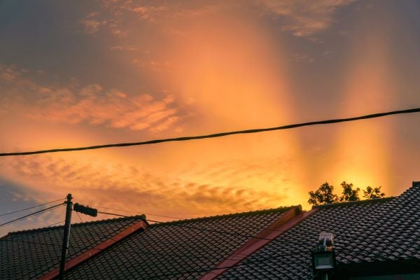 Sun setting over rooftops Unsplash