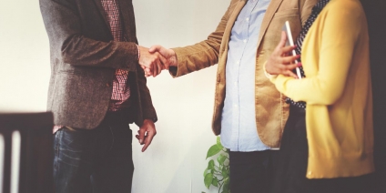 Realtor Shaking Hands with Clients